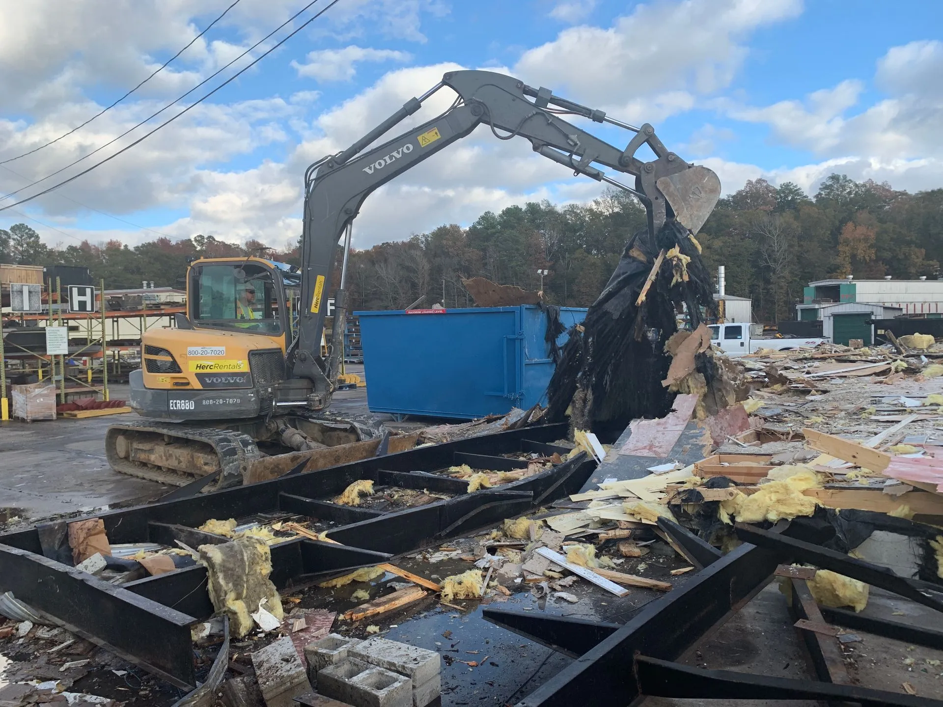 Structural Demolition With Excavator Excavator performing whole-structure demolition on a building site