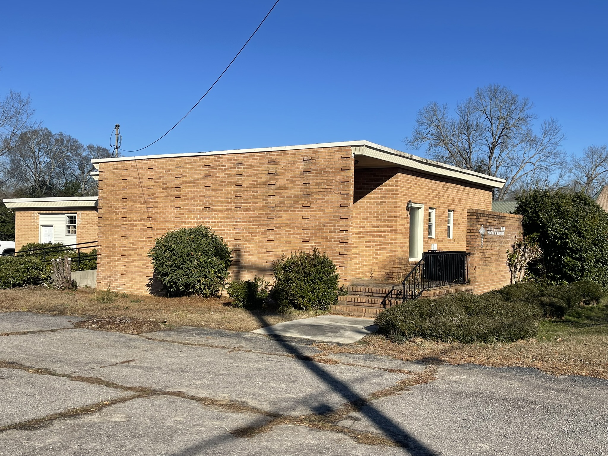 Before commercial building demolition in Denmark SC showing front and side view of brick structure