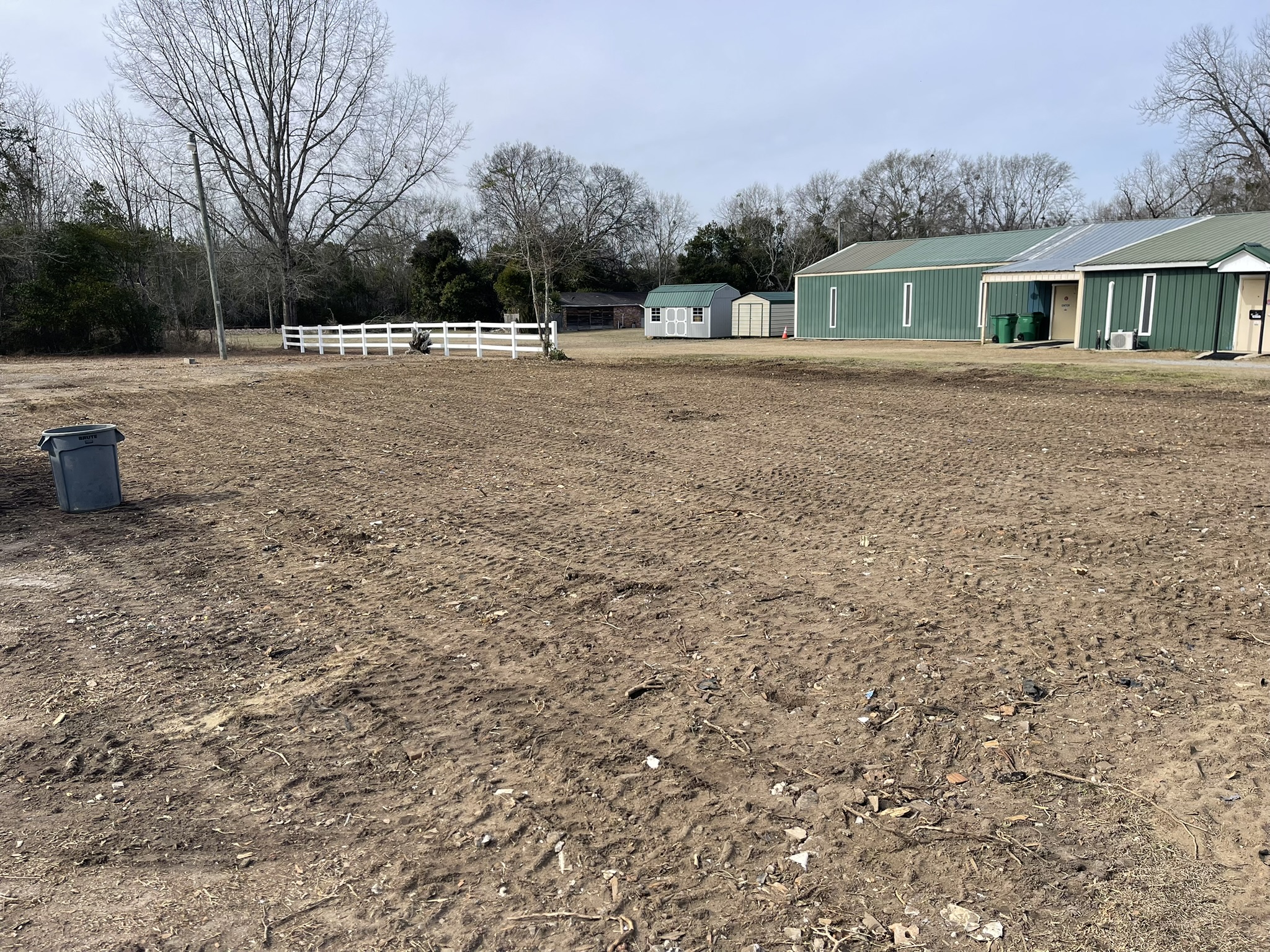 After commercial demolition in Denmark SC showing cleared dirt lot and nearby buildings