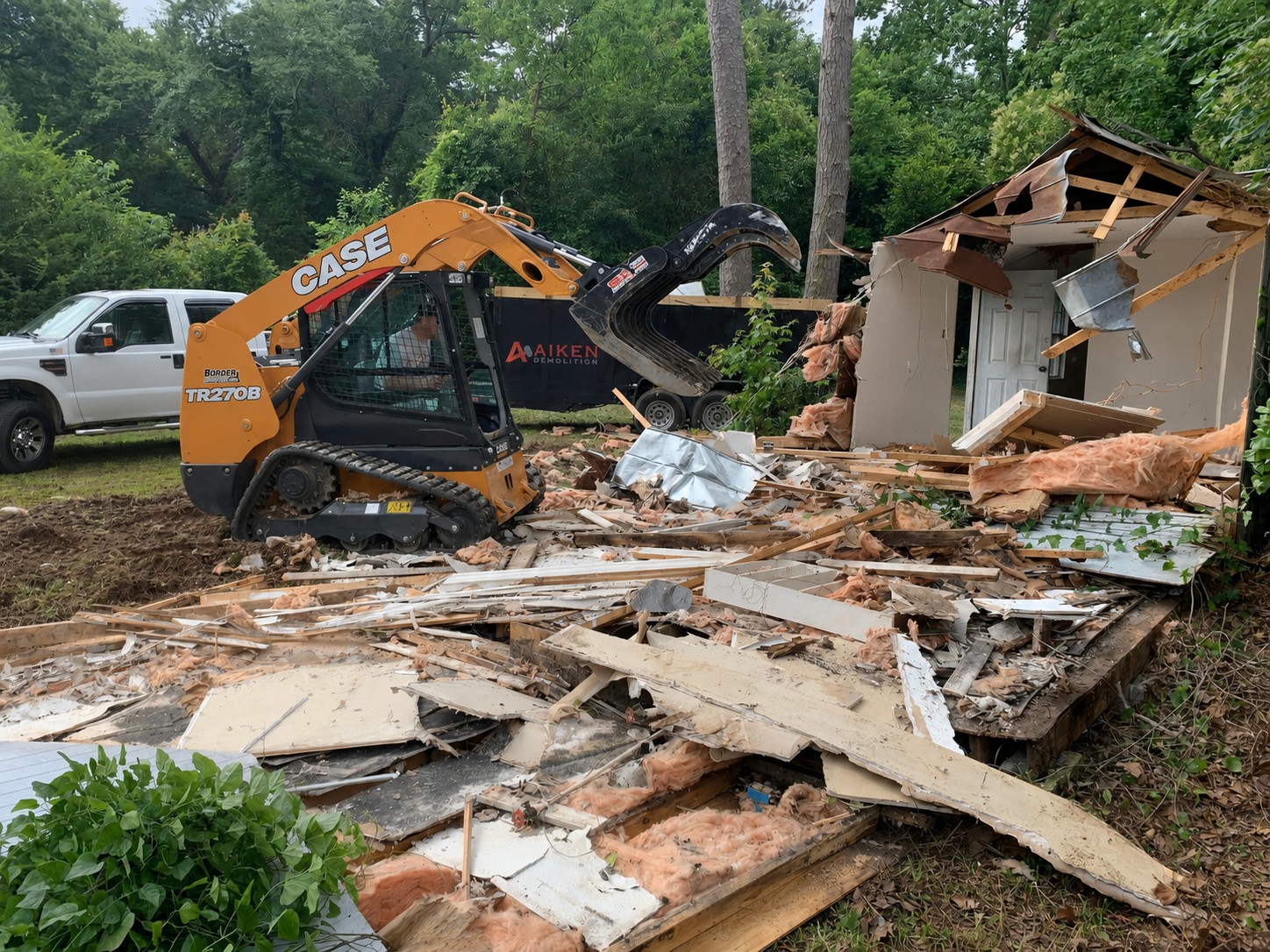 f4785885-e9aa-4 Small outdoor building being demolished during a property cleanup project