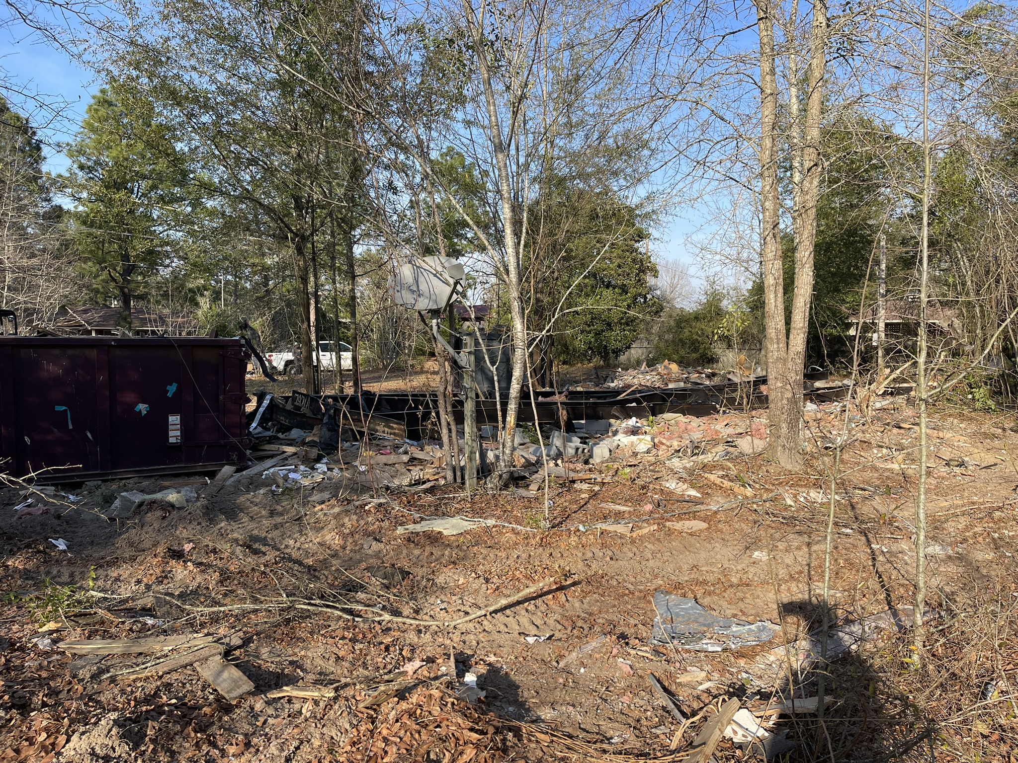 Abandoned mobile home frame and demolition debris during removal in New Ellenton