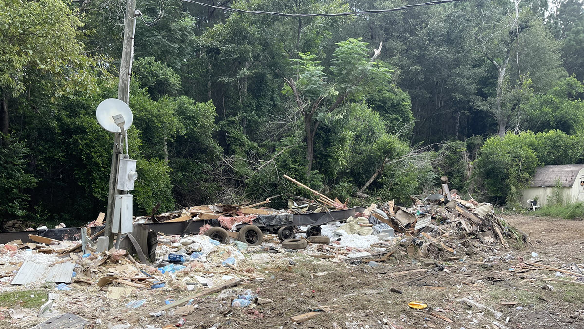Mobile home demolition debris beside utility service equipment in Aiken SC