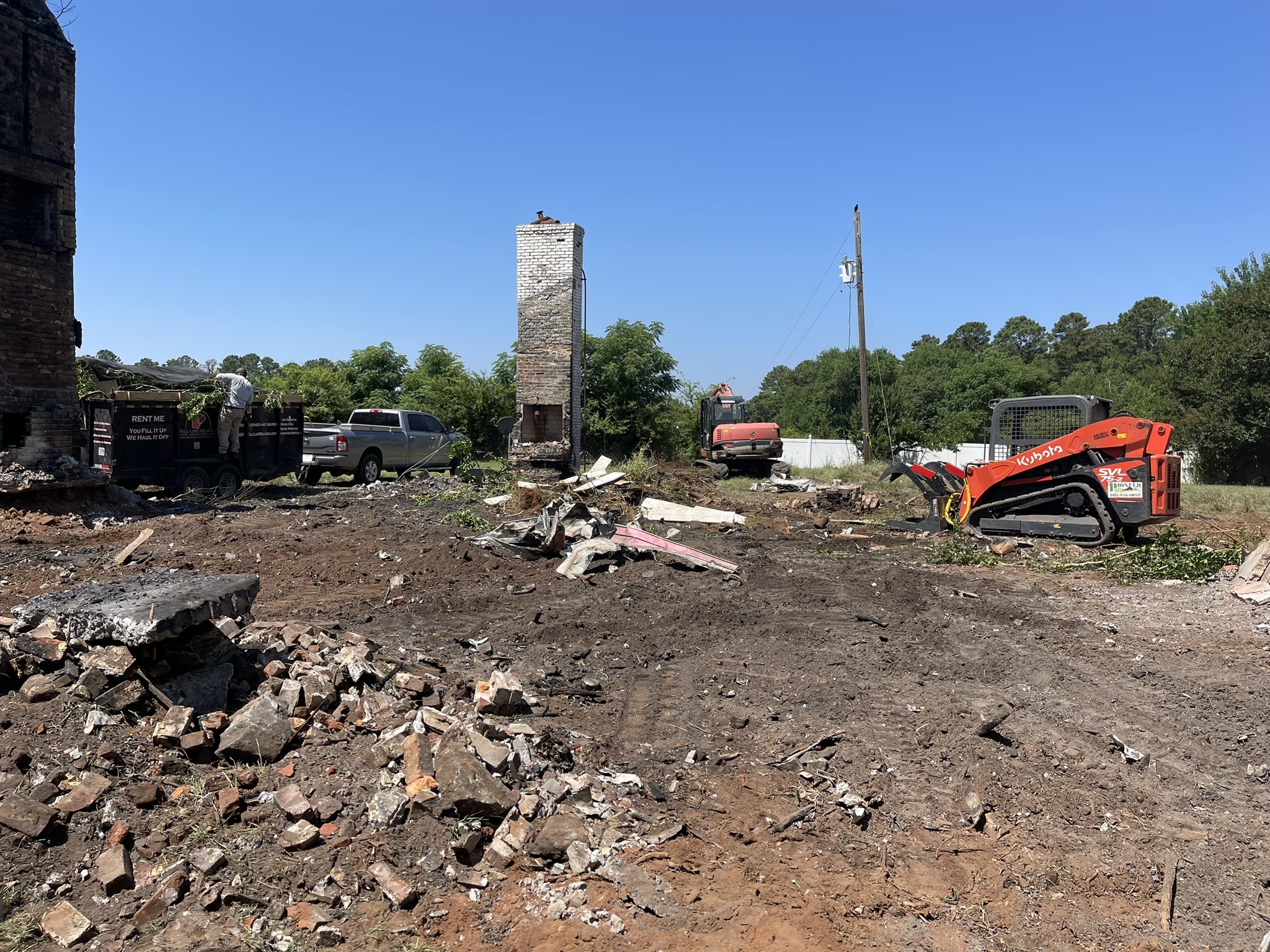 Excavator removing a house during structure demolition in Aiken SC